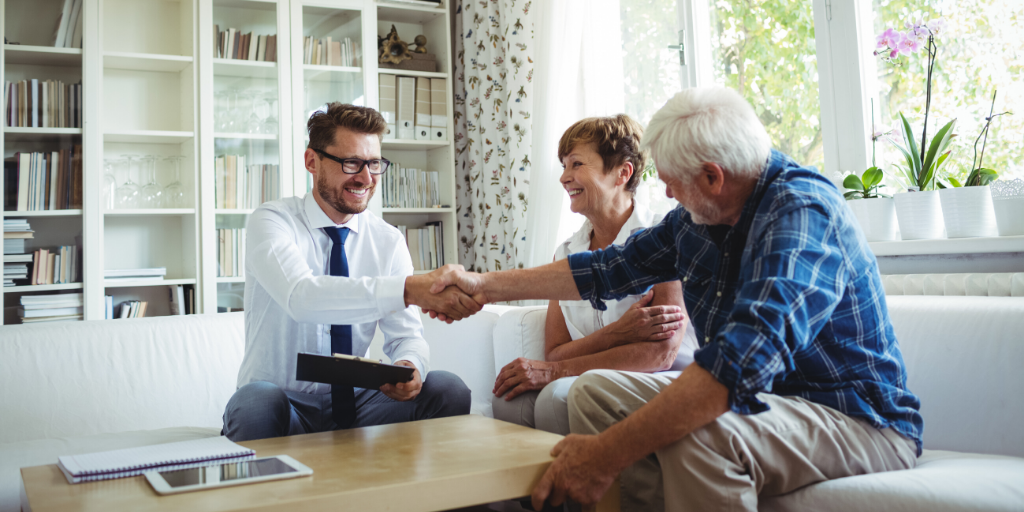 Financial Advisor Shaking Hands With Older Couple